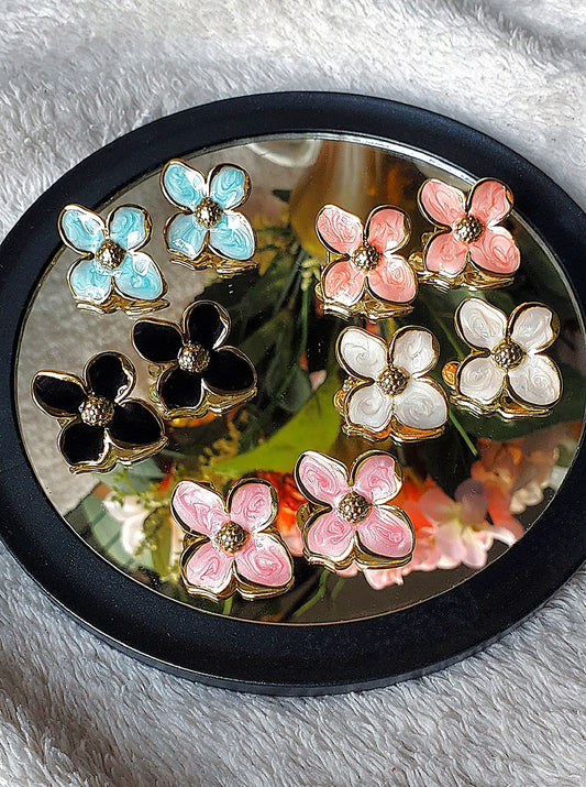 summer flower stainless steel earrings that are light blue, light pink, peach, black and creamy white.