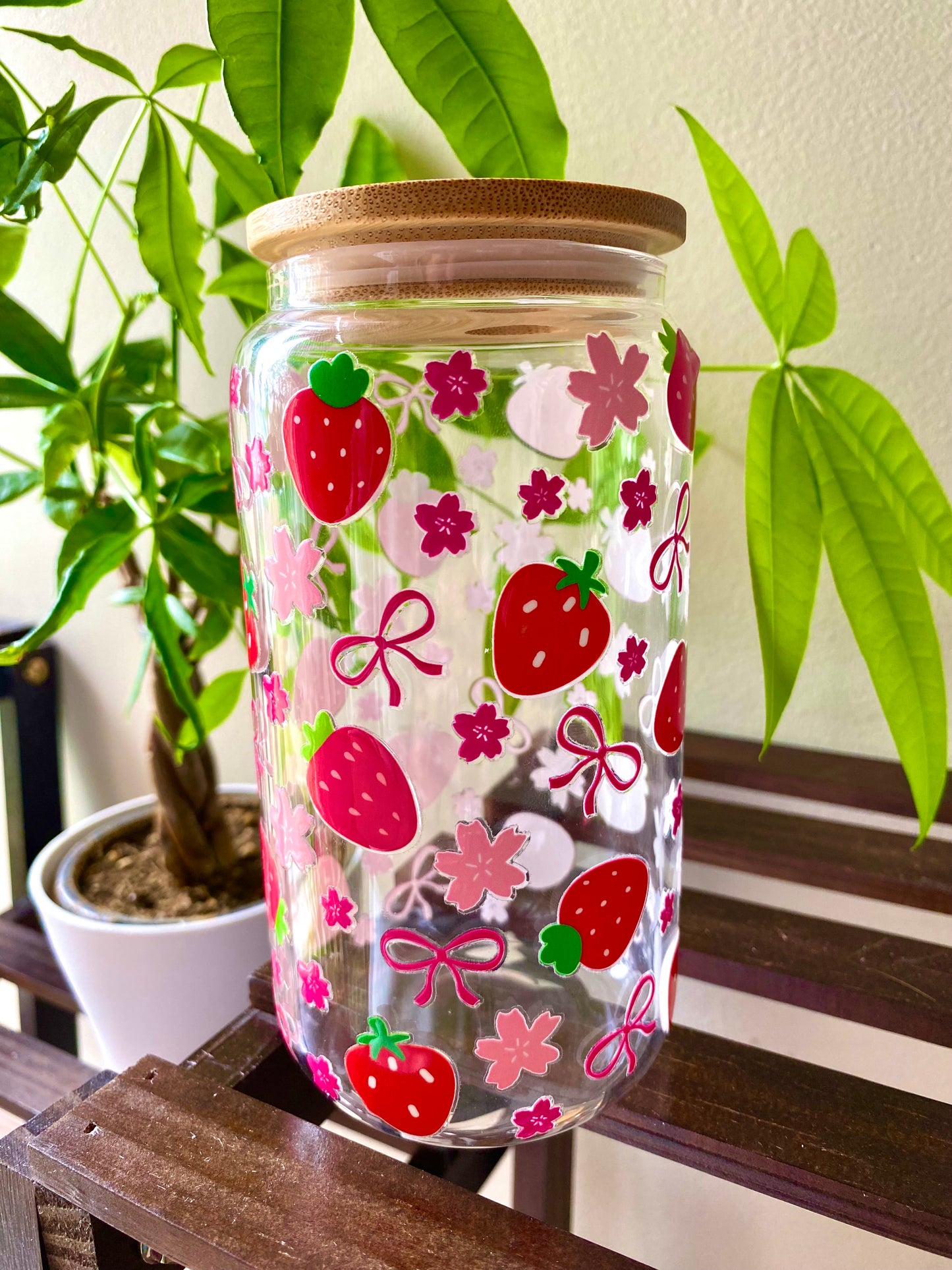 Pink and red strawberries cover the length of this 16oz glass cup. Accented with cherry blossom flowers and cute pink bows.