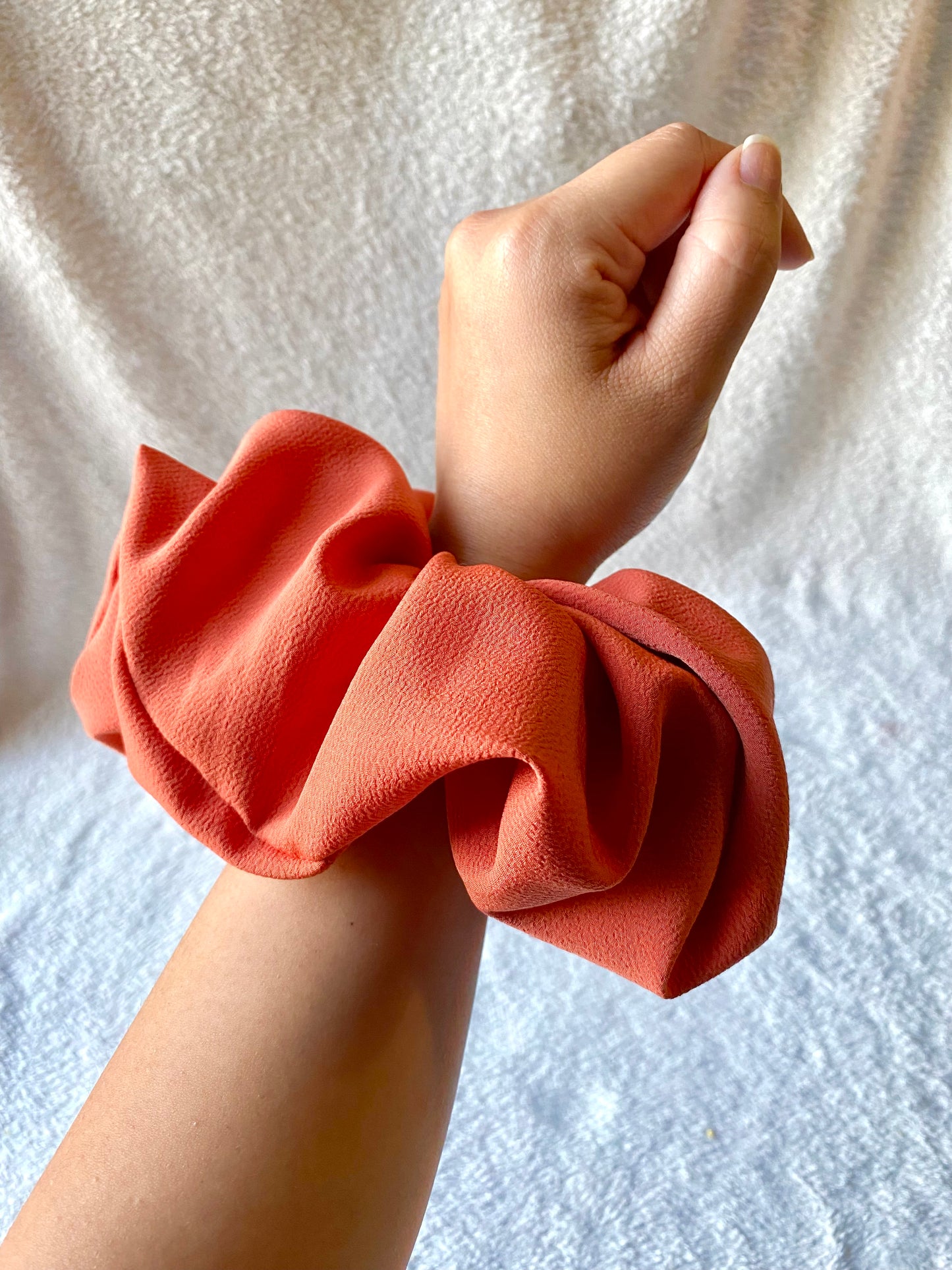 Extra large sized scrunchie. Bold, solid, orange color.