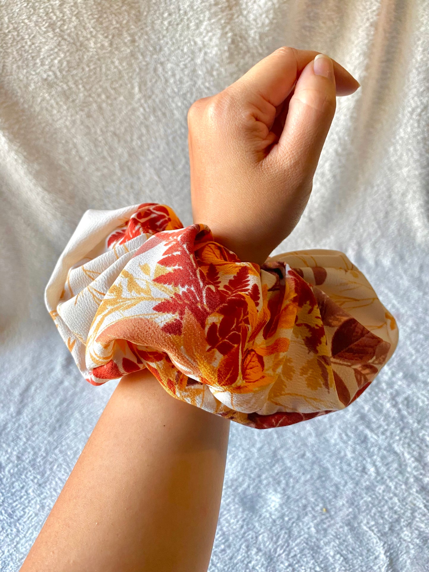 Orange, gold, red leaves displayed on this extra large scrunchie.