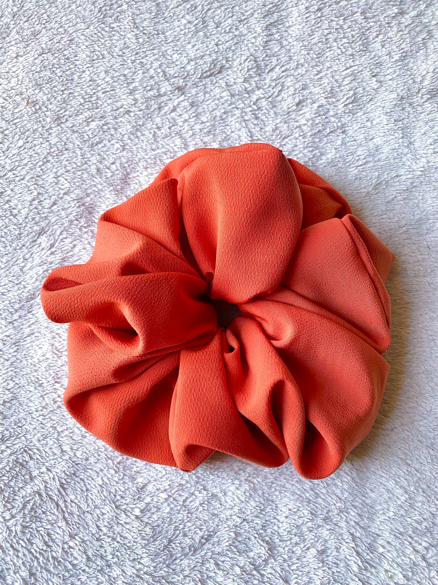 Extra large sized scrunchie. Bold, solid, orange color.