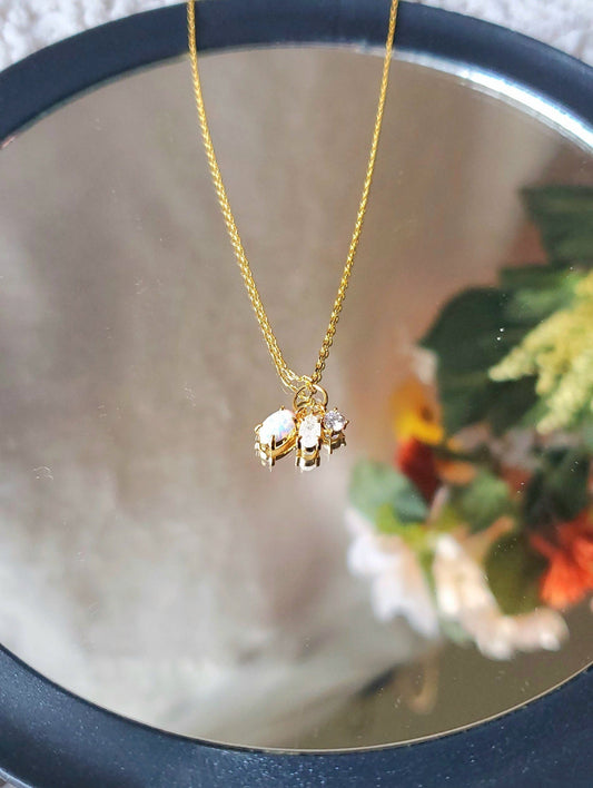 gold necklace with opal crystal charm.