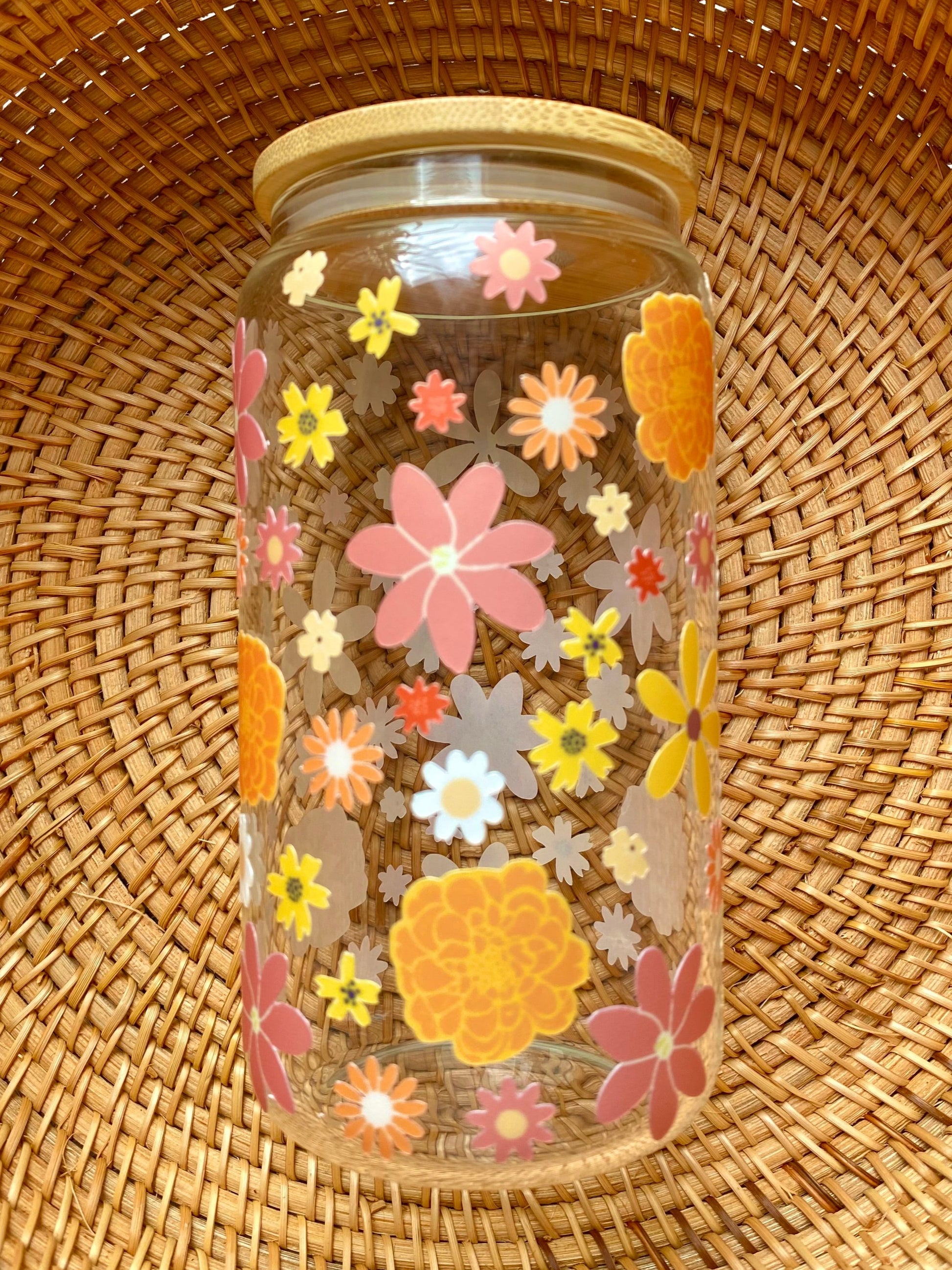 Autumn flowers of various colors cover this 16 oz glass cup.