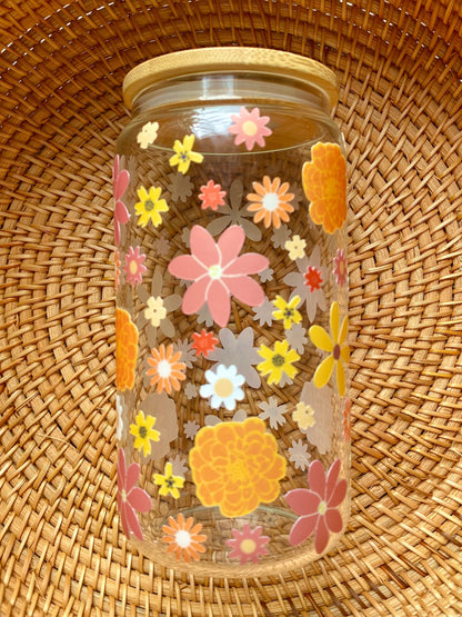 Autumn flowers of various colors cover this 16 oz glass cup.