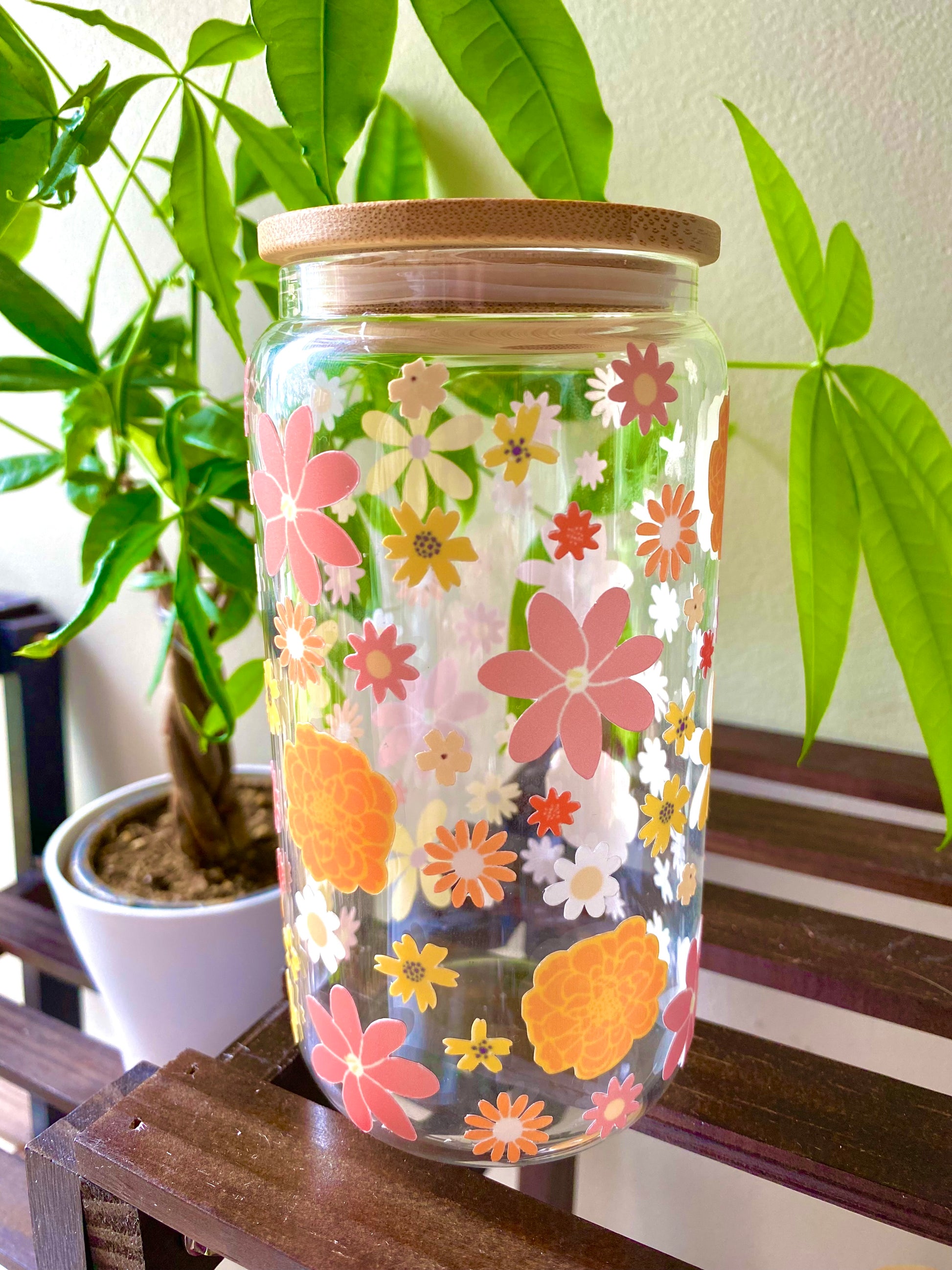Color autumn flowers cover this 160z glass cup.