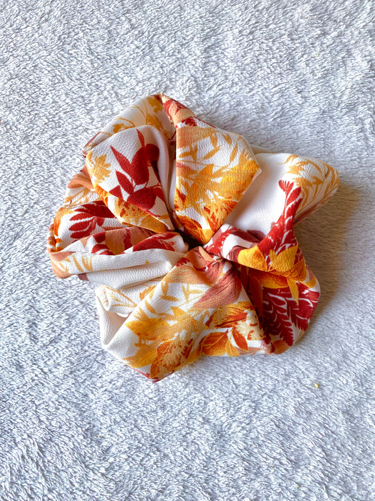 Orange, gold, red leaves displayed on this extra large scrunchie.