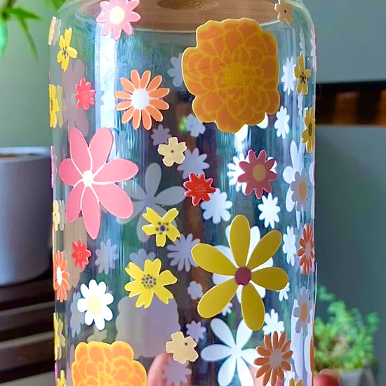 Color autumn flowers cover this 160z glass cup.