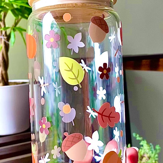 Autumn inspired 16oz glass cup with fall leaves, acorns, flowers, and small details