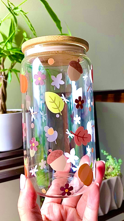Autumn inspired 16oz glass cup with fall leaves, acorns, flowers, and small details